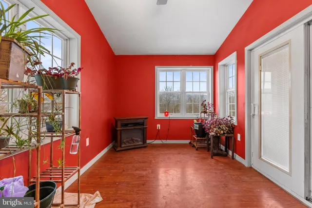 a dining room with furniture and wooden floor