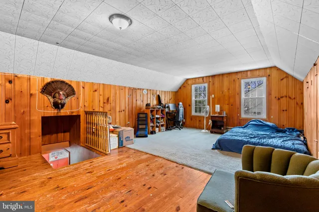 a bedroom with furniture and a large window