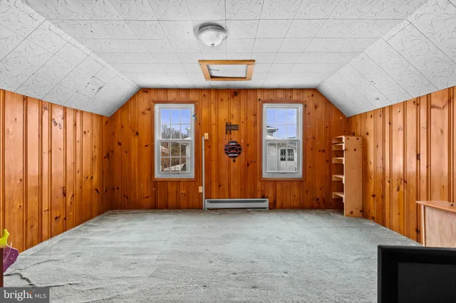 an empty room with furniture staircase and a view of bedroom