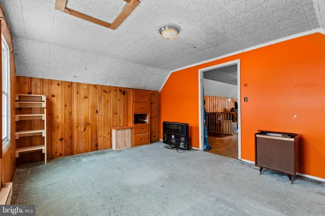 a view of empty room with wooden ceiling