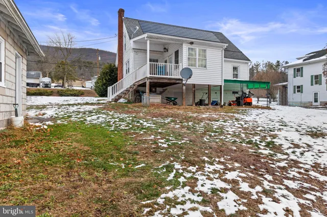 a swimming pool with outdoor seating and yard