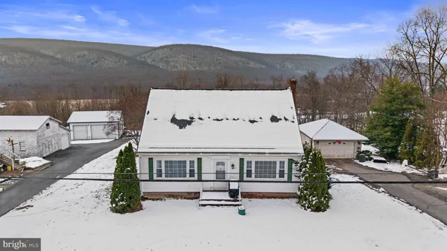 an aerial view of a house with a yard