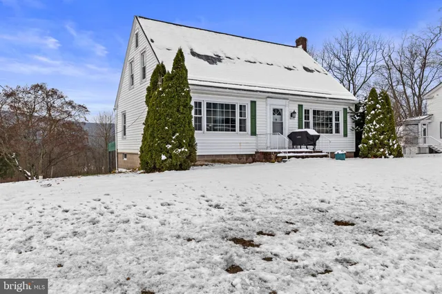 a view of a house with a snow in the yard