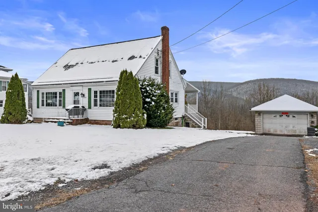 a view of a house with a snow in the background