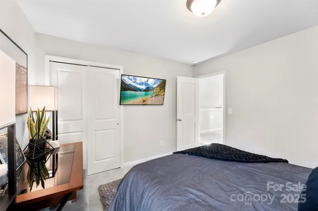 a bathroom with a granite countertop sink a toilet a mirror and shower