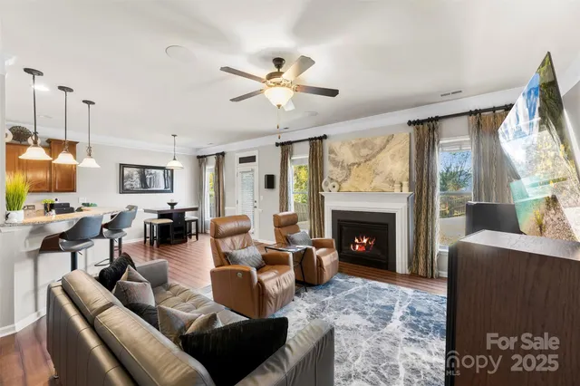 a living room with furniture a fireplace and a flat screen tv