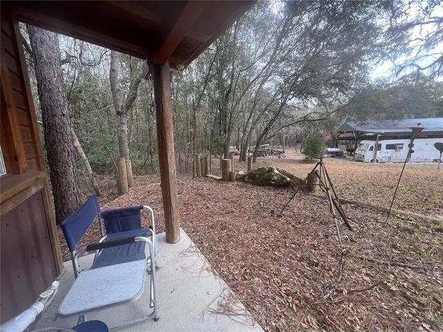 a view of a backyard with sitting area