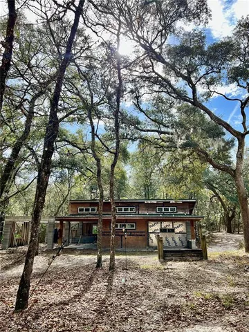 a view of a house with a snow on the road