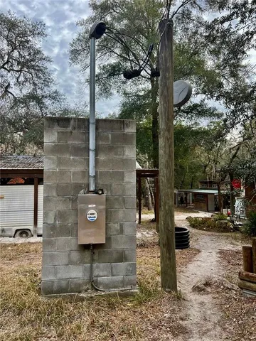 a view of a backyard with wooden fence and a bench