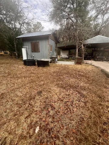 a view of a house with a yard and sitting area