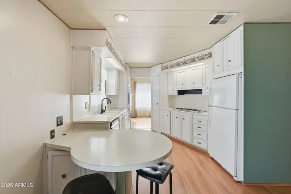 a kitchen with a refrigerator and a stove