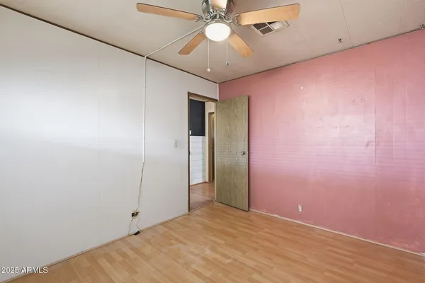 a view of a livingroom with a ceiling fan and window