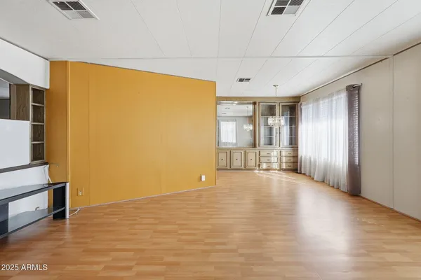 a view of a room with wooden floor