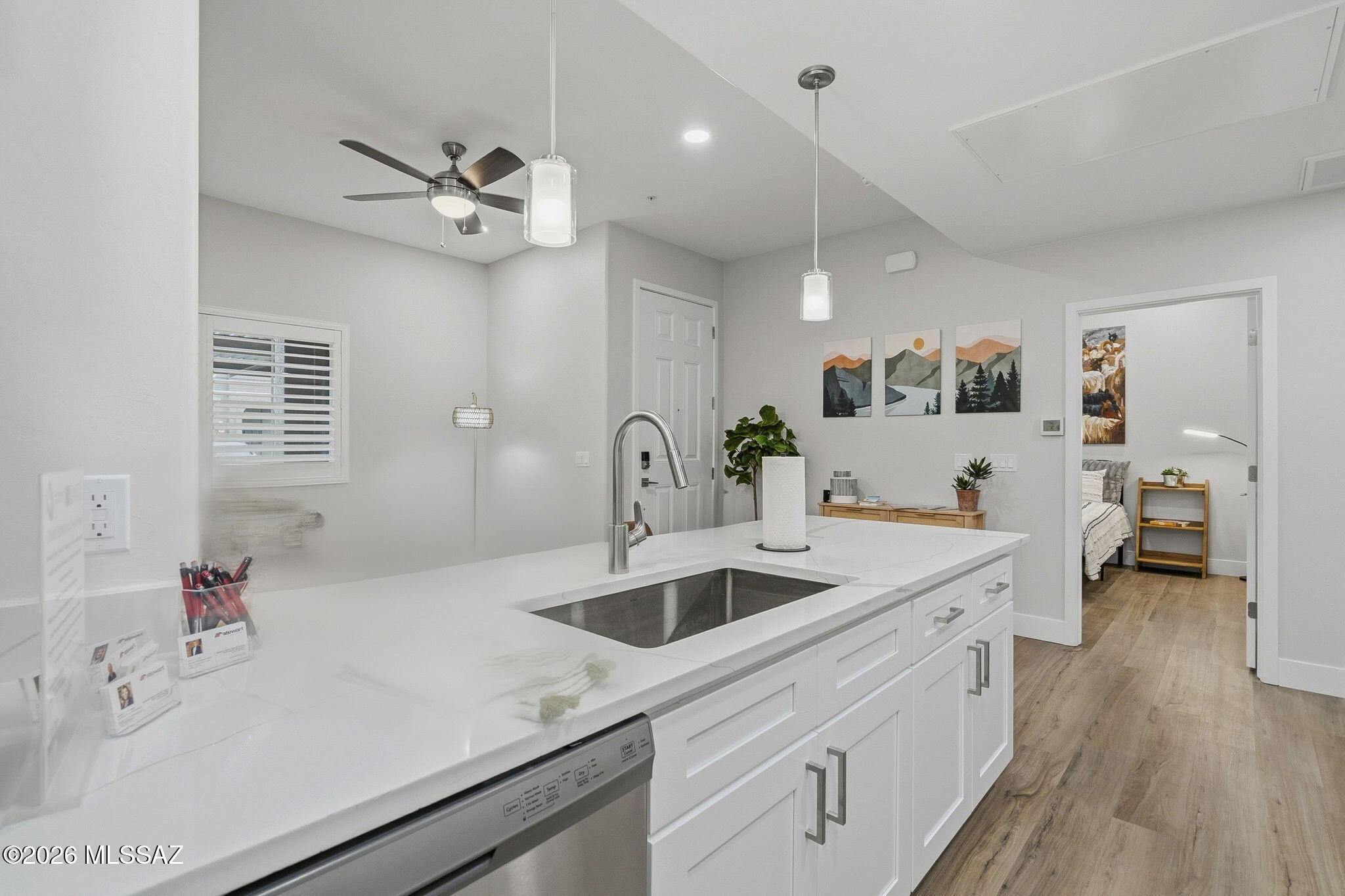 2020 East River Road, Unit 101 Tucson, AZ 85718 - Photo 5 of 12 a kitchen with a sink dishwasher a refrigerator and cabinets
