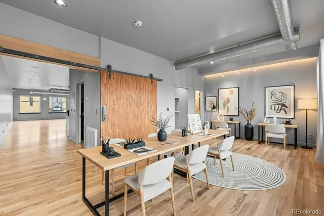 a spacious bedroom with a bed and glass window