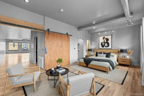 a workspace with wooden floor and furniture