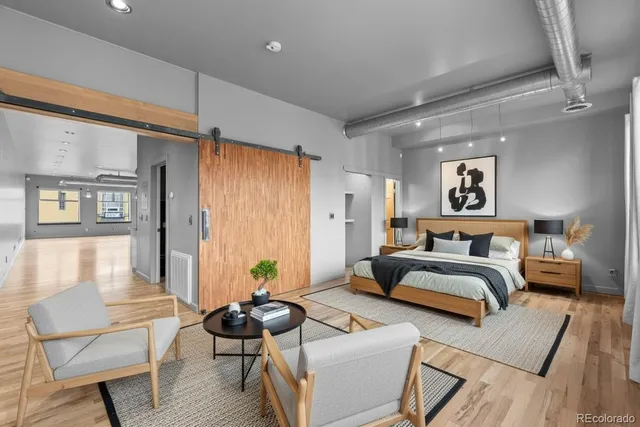 a workspace with wooden floor and furniture