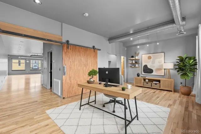 a living room with furniture a flat screen tv and a large window