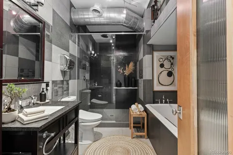 a bathroom with a granite countertop sink a shower and a mirror