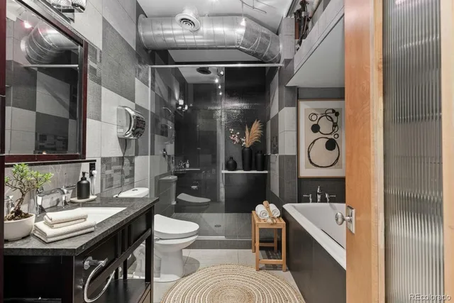 a bathroom with a granite countertop sink a shower and a mirror