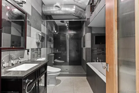 a bathroom with a sink a toilet and a mirror