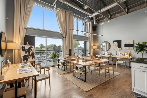 a living room with lots of furniture and a large window