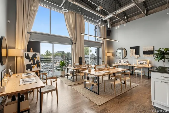 a living room with lots of furniture and a large window