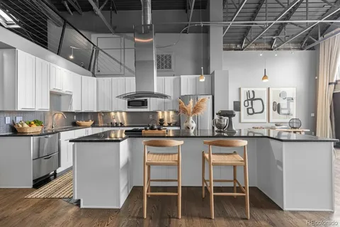 a kitchen with stainless steel appliances granite countertop a sink a stove and cabinets