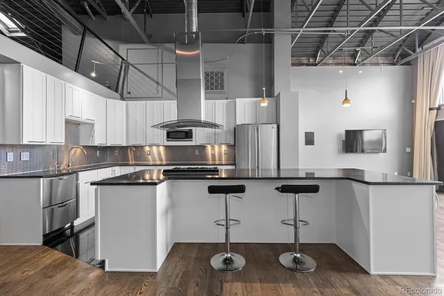 a bathroom with a double vanity sink toilet and shower