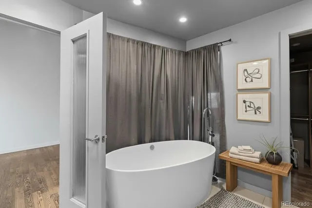 a view of walk in closet with clothes and shoes