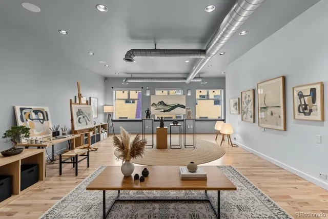 a living room with lots of furniture and view of kitchen