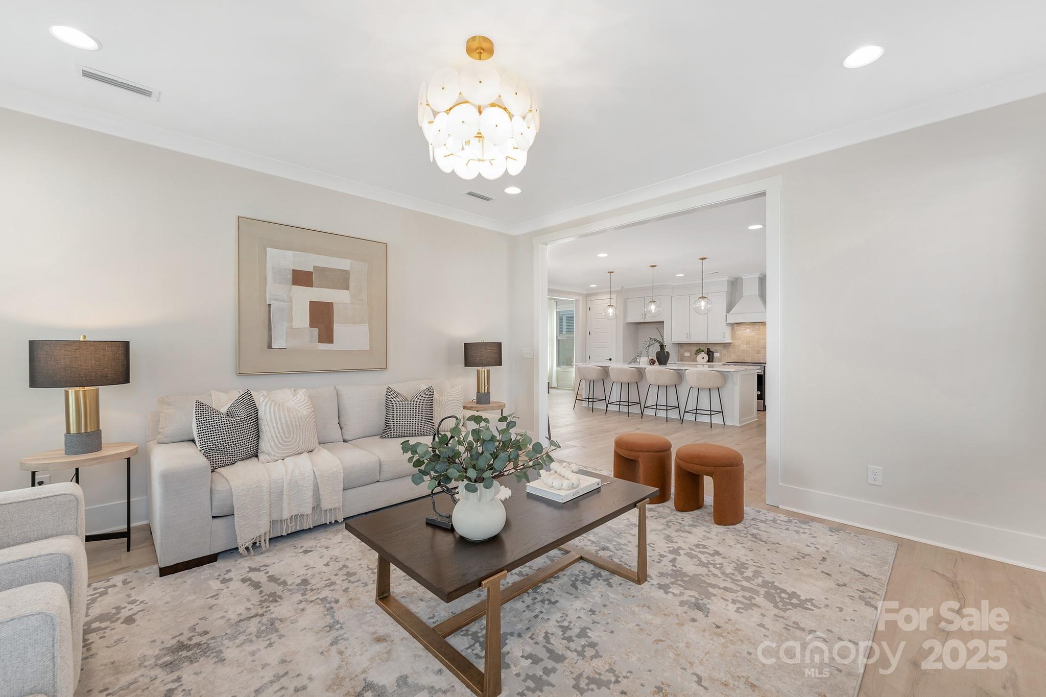 109 Seldon Drive Charlotte, NC 28216 - Photo 14 of 35 a living room with furniture and a chandelier
