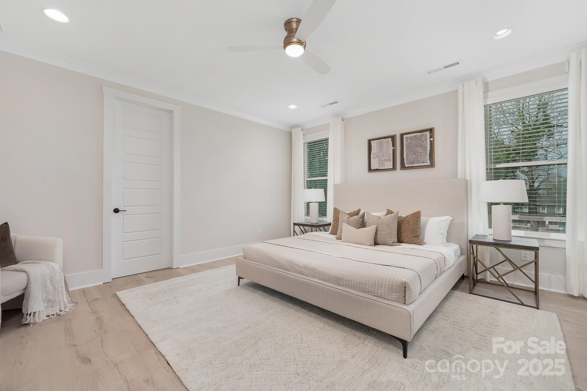 109 Seldon Drive Charlotte, NC 28216 - Photo 19 of 35 a bedroom with a large bed a couch and large window