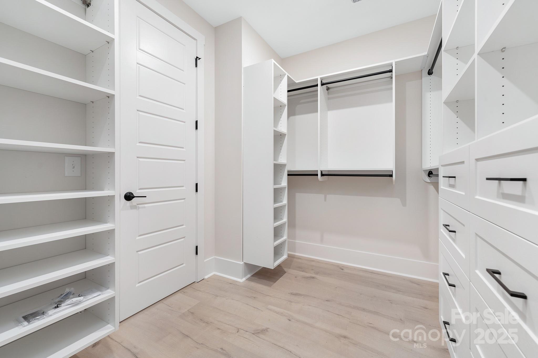 109 Seldon Drive Charlotte, NC 28216 - Photo 21 of 35 a view of walk in closet with empty racks
