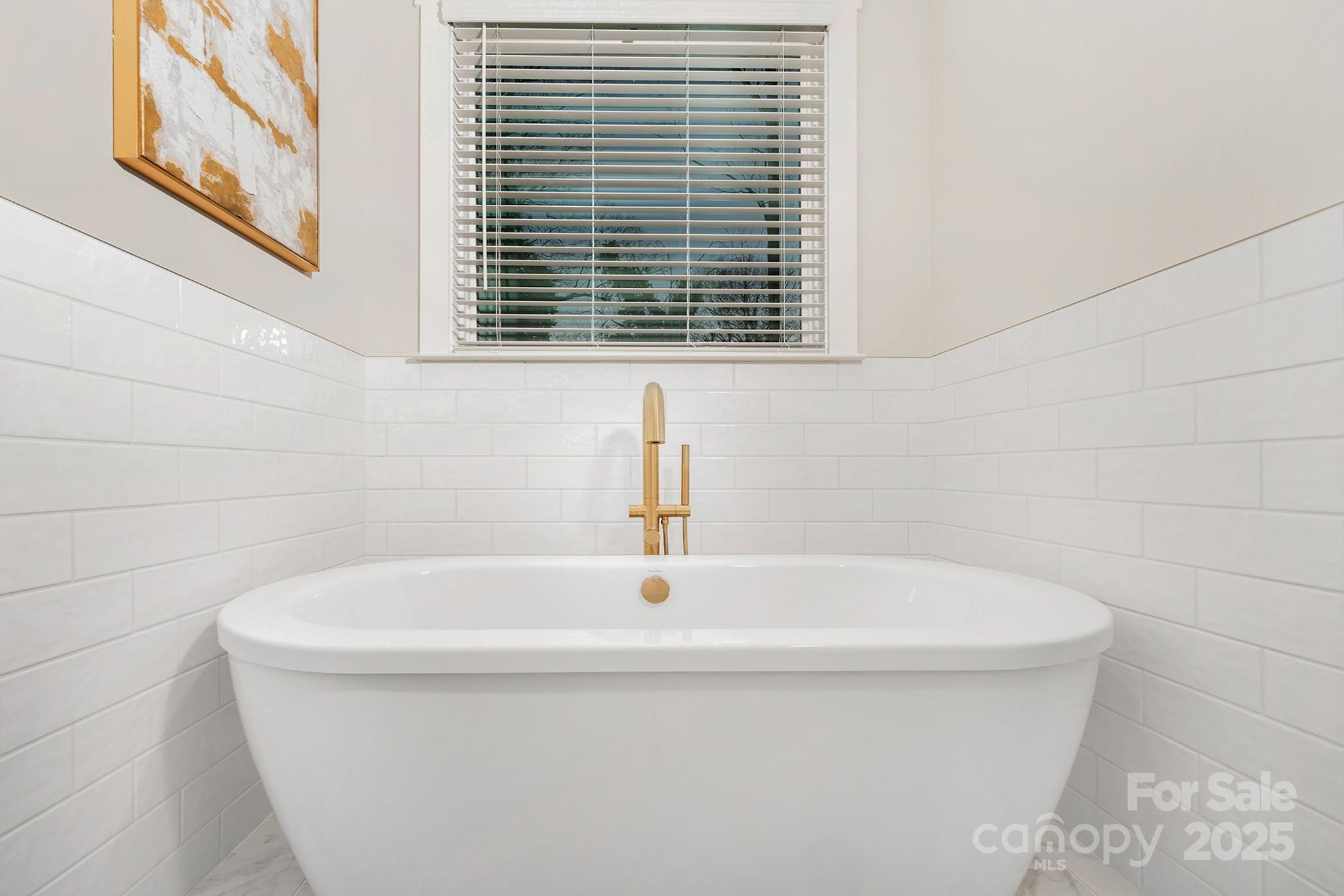 109 Seldon Drive Charlotte, NC 28216 - Photo 25 of 35 a white bath tub sitting in a bathroom next to a window