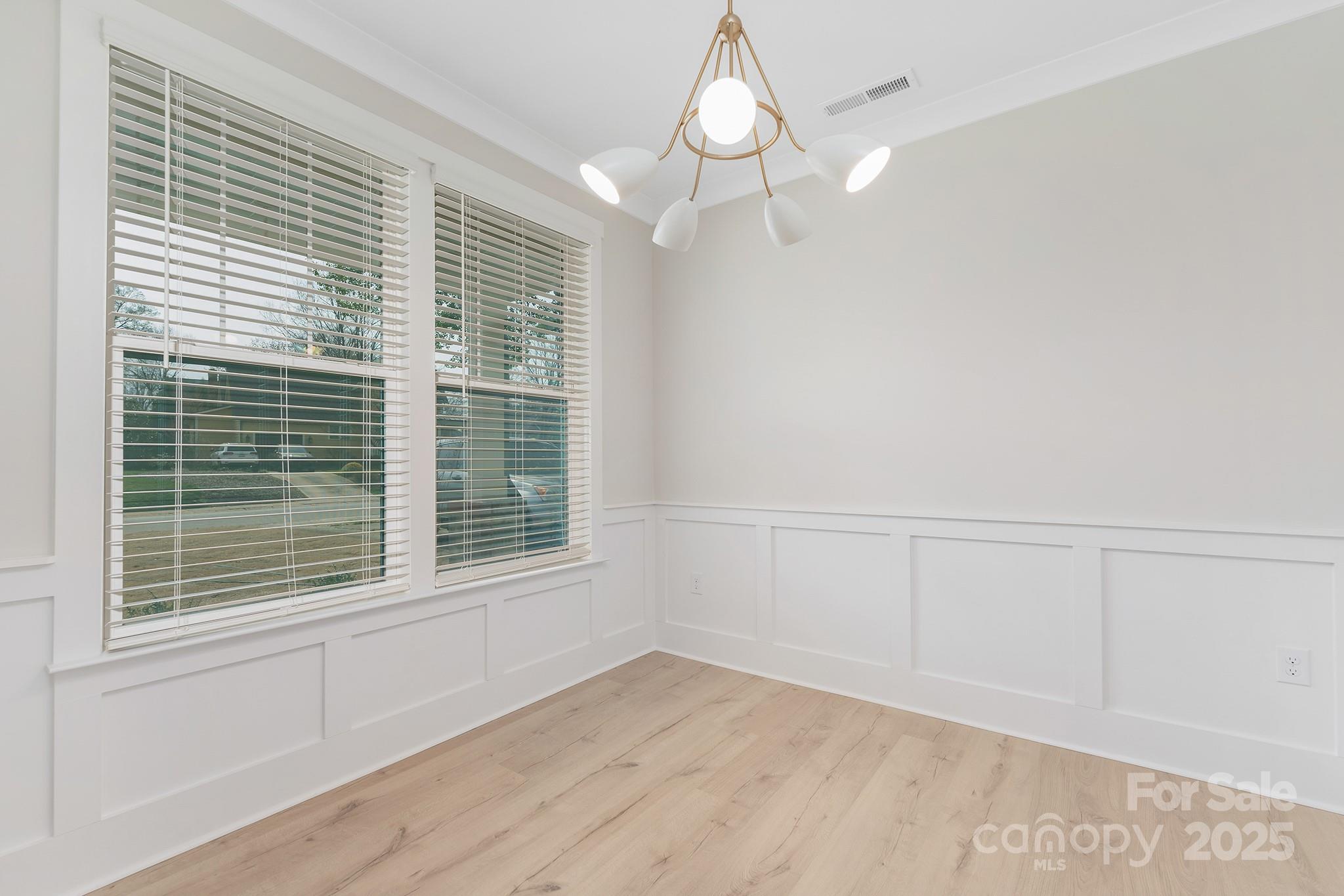 109 Seldon Drive Charlotte, NC 28216 - Photo 5 of 35 a view of an empty room with a window and wooden floor