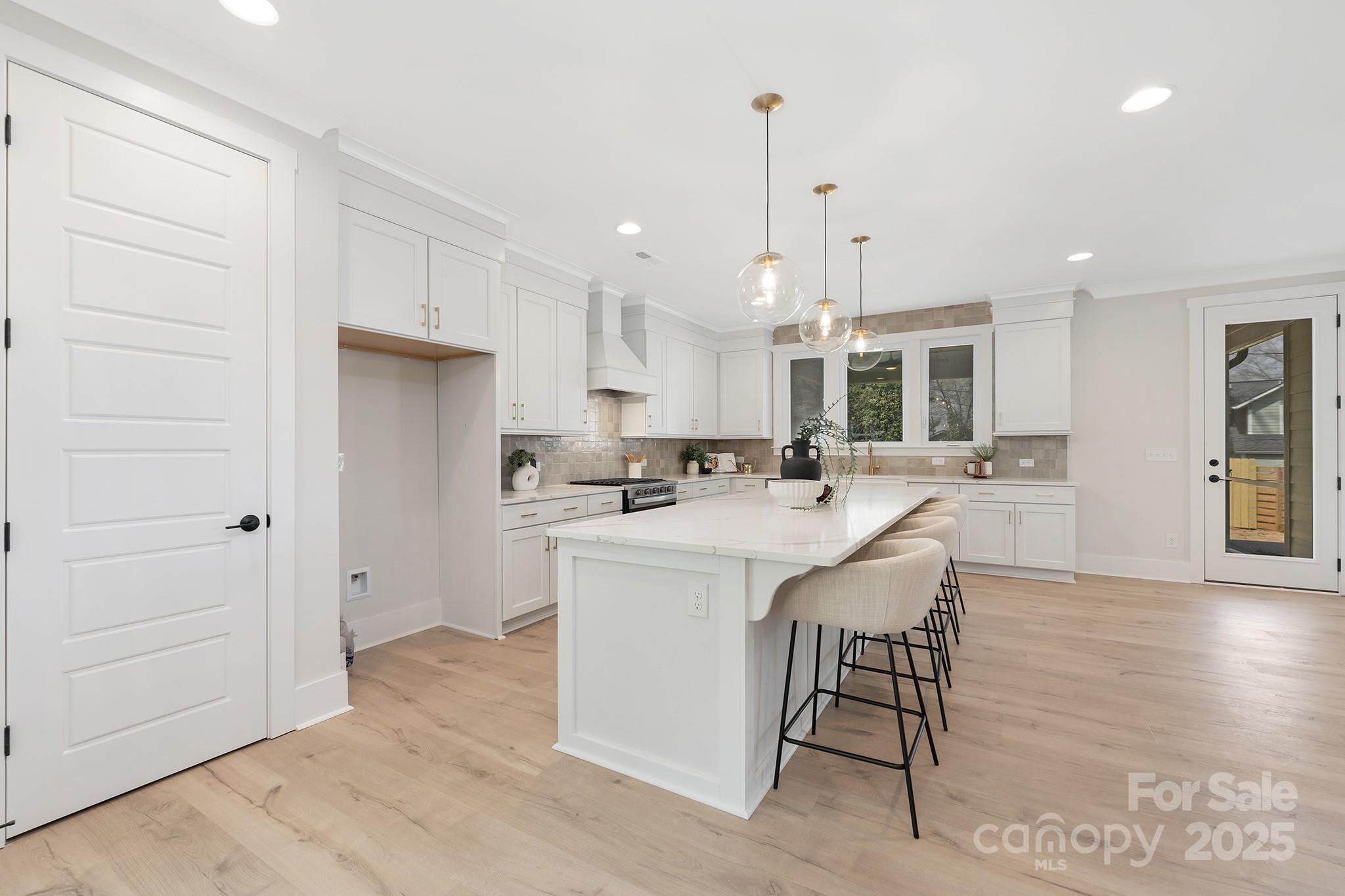 109 Seldon Drive Charlotte, NC 28216 - Photo 9 of 35 a kitchen with stainless steel appliances kitchen island granite countertop a table chairs and a refrigerator