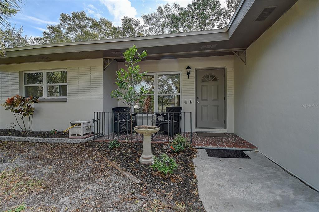 a backyard of a house with table and chairs