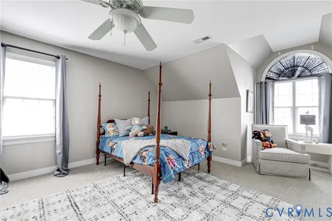 a bathroom with double vanity sink a mirror and a toilet