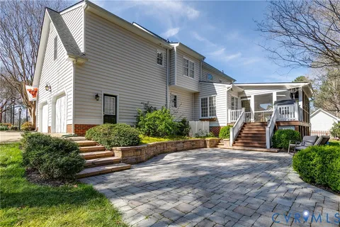 a view of a house with backyard and sitting area