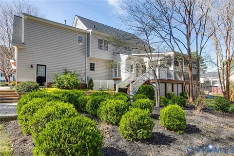 a view of a house with a yard and sitting area