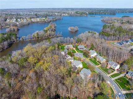 an aerial view of lake and residential houses with outdoor space
