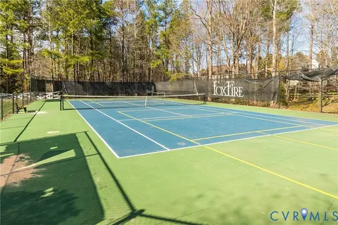 a view of outdoor space with swimming pool and trees in the background