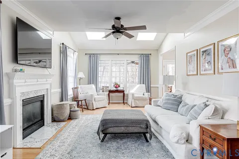 a living room with furniture a fireplace and a flat screen tv