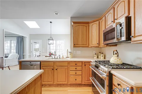 a kitchen with stainless steel appliances granite countertop a sink stove and cabinets