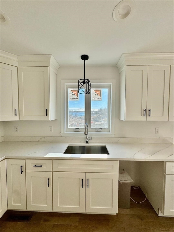 917 Dwelly Street Fall River, MA 02724 - Photo 13 of 22 a kitchen with white cabinets and sink