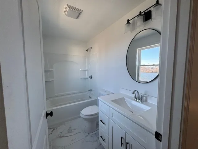 a bathroom with a sink toilet and a mirror