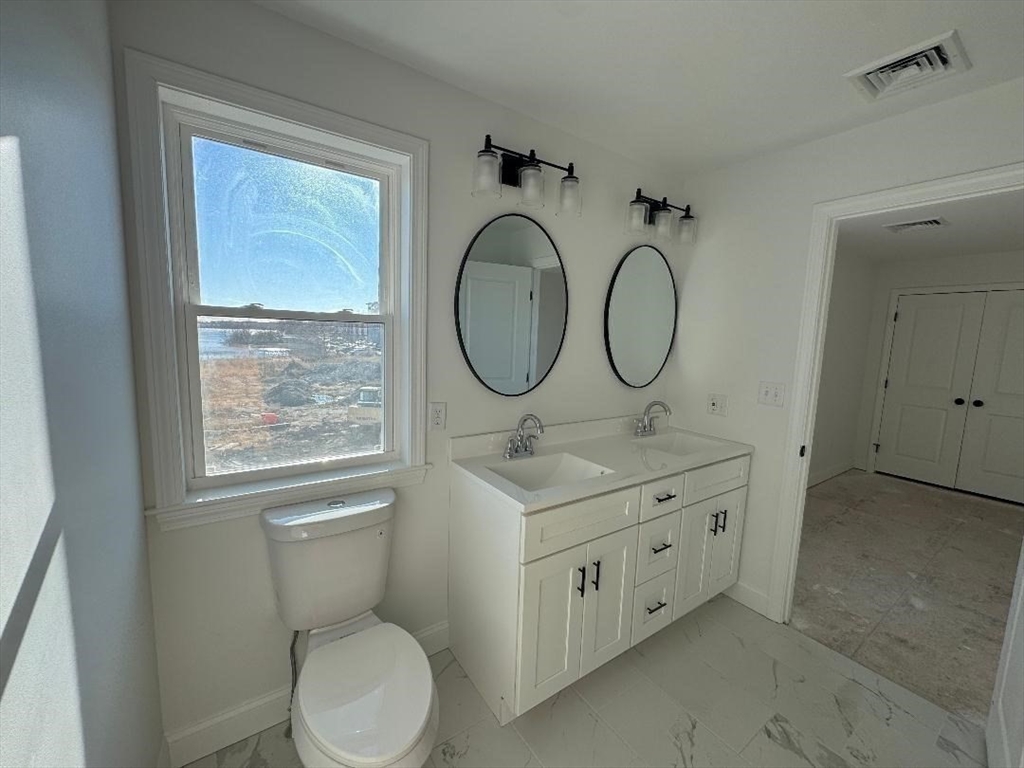 917 Dwelly Street Fall River, MA 02724 - Photo 17 of 22 a bathroom with a toilet sink and mirror