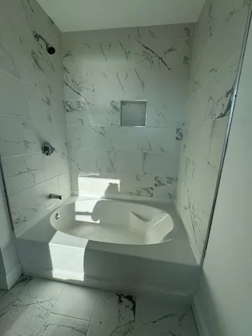a bathroom with a sink a toilet and bathtub