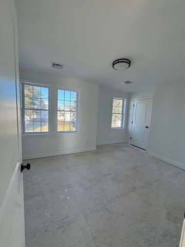a view of an empty room with windows